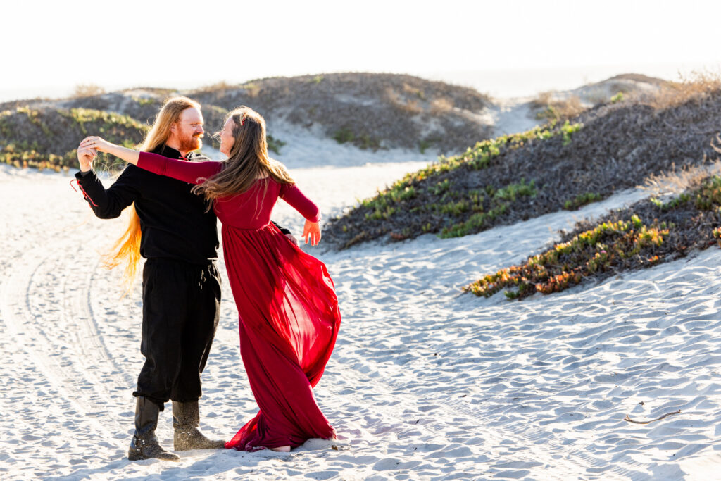 A Family Photographer Coronado Session: The Sequel Family enjoying a themed beach photoshoot in Renaissance-inspired attire in Coronado
